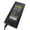 A Replacement AC Adaptor features a black design with a label displaying specifications, warning icons, certification logos, and "Made in China" text. A power cord extends from the bottom left of the adaptor.